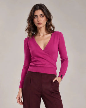 Close-up of the Alba Malva sweater showing the crossover V-neck front, long sleeves and ribbed hem.