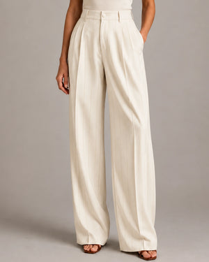 Front detail of the ivory Amata Panna wide-leg trousers showing fine gold-coloured vertical pinstripes and front pleats.