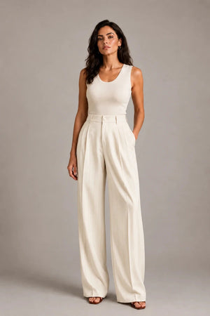 Full-length front view of the ivory Amata Panna wide-leg trousers with fine gold-coloured pinstripes, styled with an ivory sleeveless top.