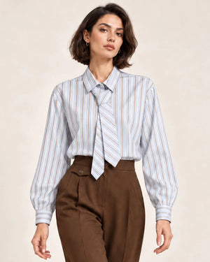 Close-up front view of a pale blue, white and almond striped shirt with a matching necktie.