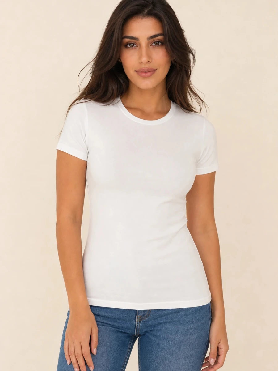 White crew-neck short-sleeve top worn untucked with blue jeans, front view