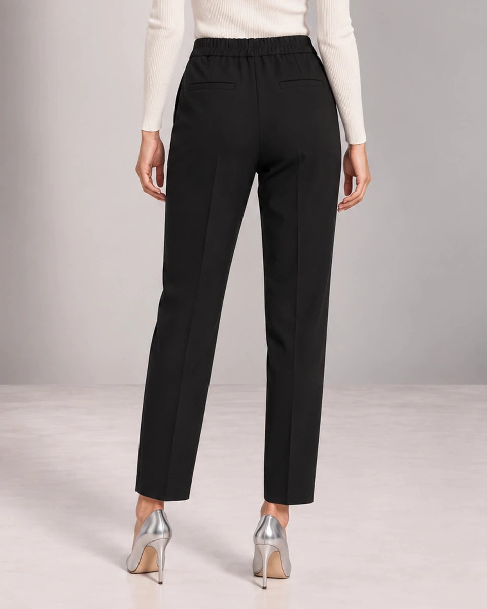 Back detail of black Bianca tailored trousers showing the gathered waistband, horizontal pocket openings and straight legs.