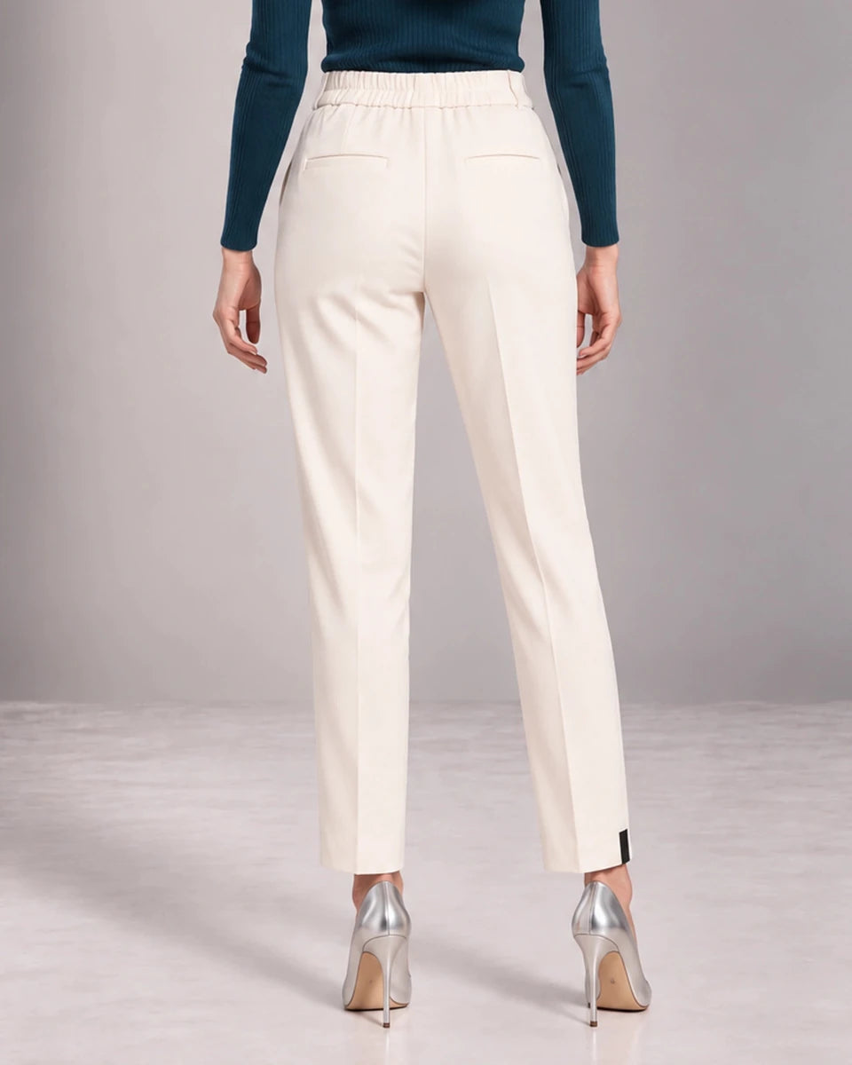 Back detail of cream Bianca tailored trousers showing the gathered waistband, horizontal pocket openings and straight legs.