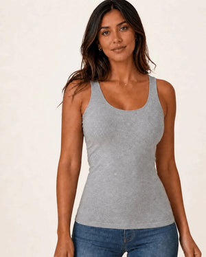 Grey longline tank top worn with blue jeans, front view