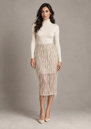 Full-length front view of the Consuelo cream fringe sequin skirt, worn with an ivory long-sleeve top.