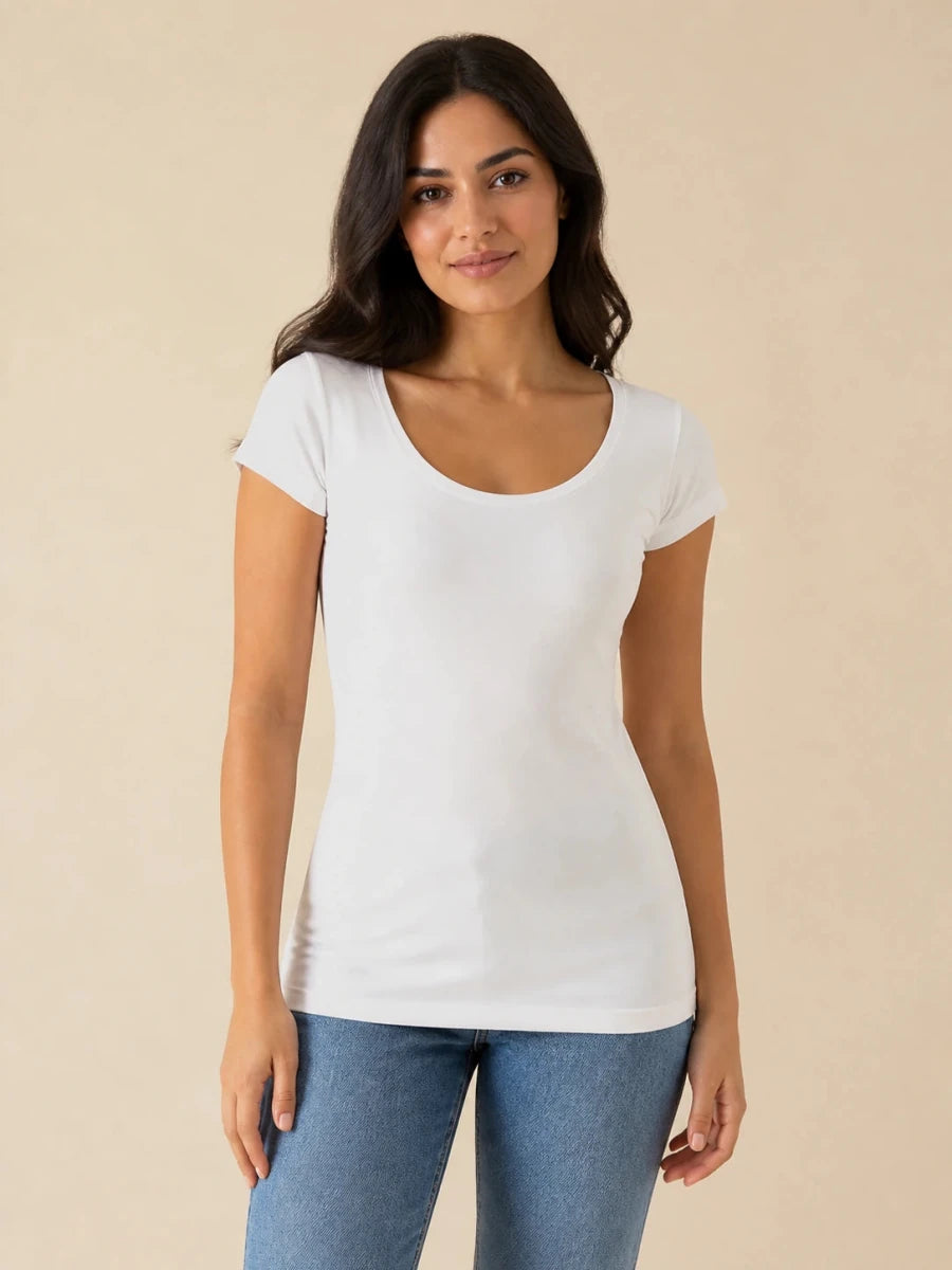 White scoop-neck cap-sleeve top worn untucked with blue jeans, front view