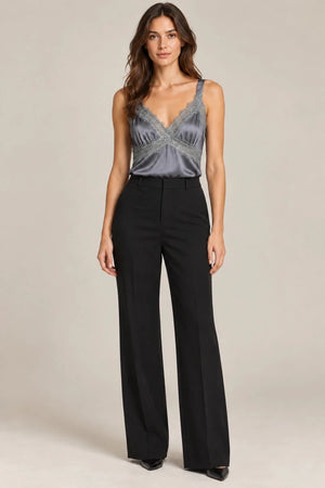 Full-length styling view of the grey Domitilla lace-trim camisole tucked into black wide-leg trousers.