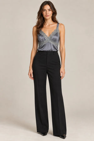 Full-length styling view of the grey Domitilla lace-trim camisole tucked into black wide-leg trousers.