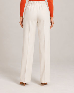 Rear detail of the ivory Elisa Panna tailored trousers showing the gathered waistband and wide legs.
