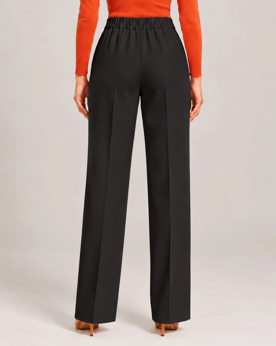 Back detail of Elisa Nero tailored trousers showing the gathered waistband and straight, full-length legs.