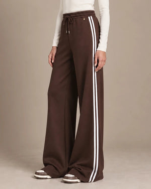 Mara Moro wide-leg track pants showing the drawstring waistband, small star detail and paired white side stripes.
