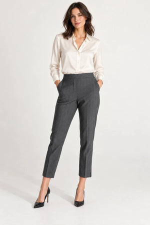 Model wearing ELLY Pantaloni Gessati Grigio grey pinstripe trousers with an ivory blouse and black heels, full-length view.