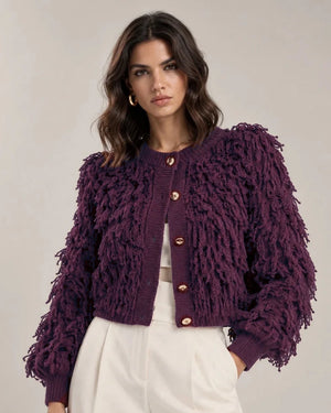 Close-up of the Viola cardigan showing its fringe-textured surface, round neckline, gold-tone buttons and ribbed cuffs.