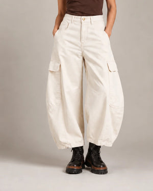 Front detail of the ivory Vittoria Panna Cargo Balloon Trousers showing the waistband, flap cargo pockets and curved balloon legs.