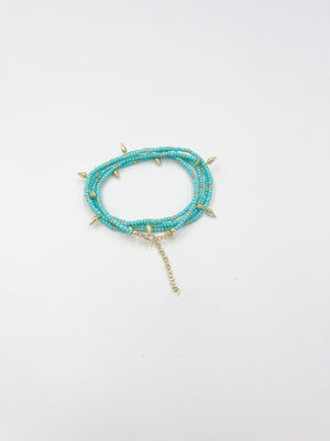 Beads necklace featuring 18 karat gold plated ornaments that can be styled as a bracelet or belt. - ELLY