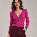 Close-up of the Alba Malva sweater showing the crossover V-neck front, long sleeves and ribbed hem.