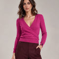 Close-up of the Alba Malva sweater showing the crossover V-neck front, long sleeves and ribbed hem.
