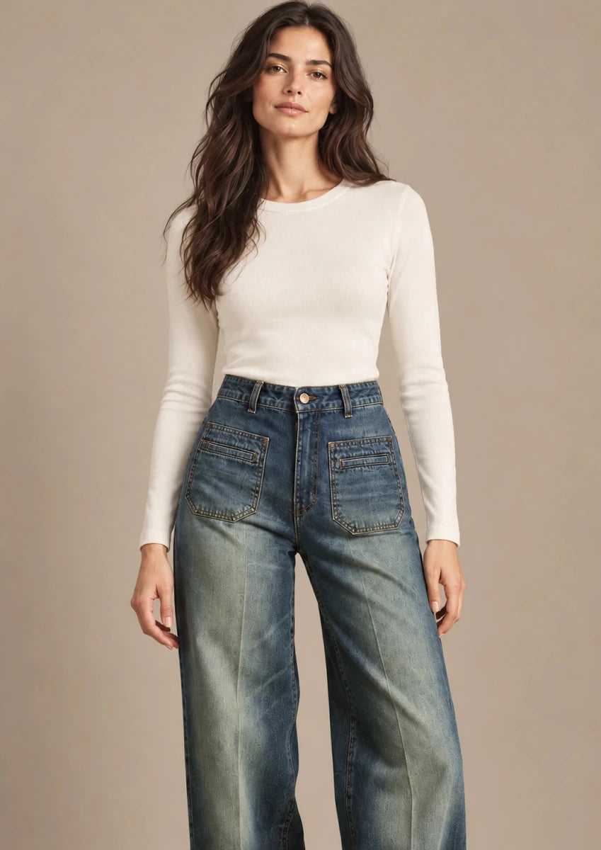Front view of Amber blue wide-leg jeans with a high waist and large front patch pockets, styled with an ivory top.