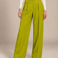 Front detail of Arianna Lime wide-leg trousers showing the button waistband, front pleats and small buttoned flap detail.