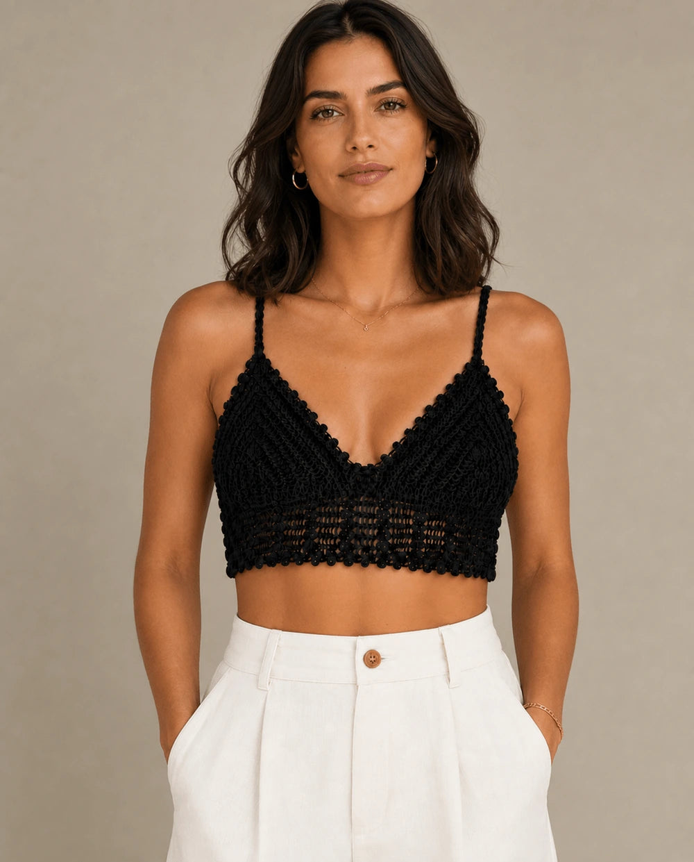 Front flat-lay view of the ELLY black crochet bralette top with triangular cups, slim straps, and a decorative openwork band.