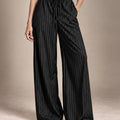 Close-up of the Bridget black pinstripe wide-leg trousers, showing the gathered drawstring waist and side pockets.