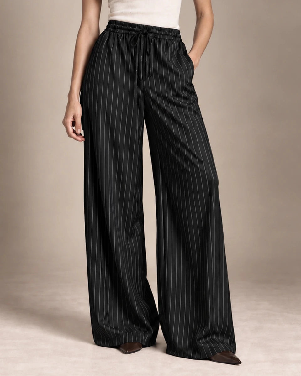 Close-up of the Bridget black pinstripe wide-leg trousers, showing the gathered drawstring waist and side pockets.