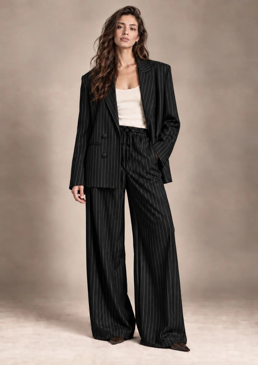 Full-length view of the Alba black pinstripe blazer and matching Bridget wide-leg trousers.