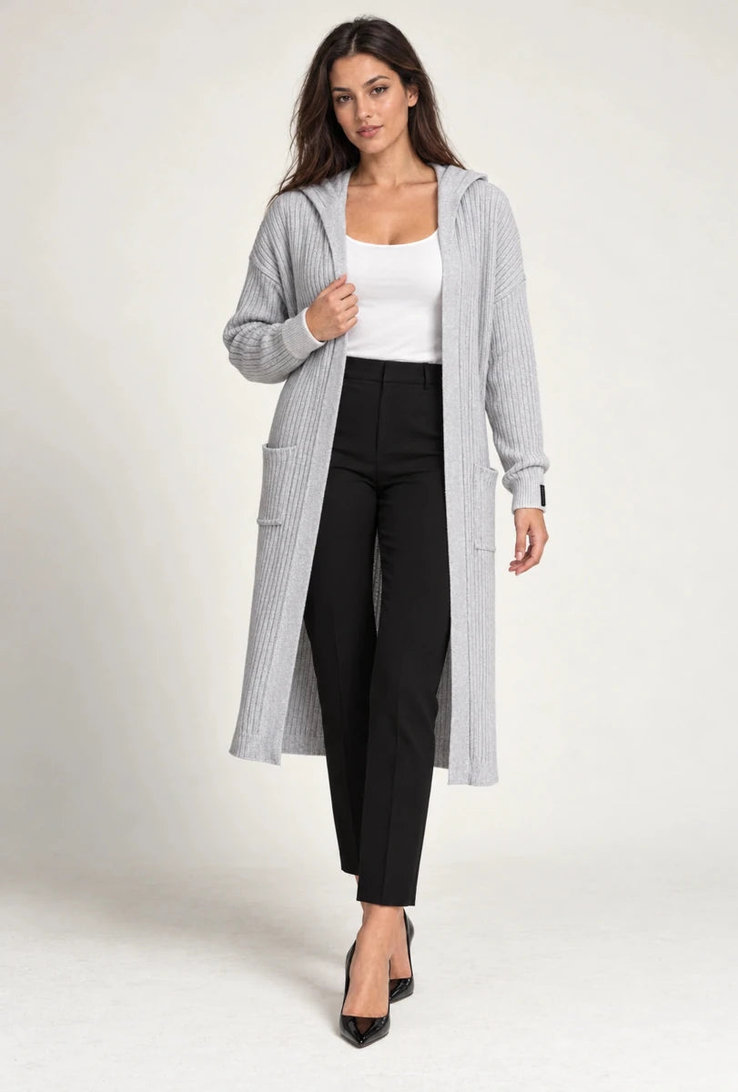 Model wearing ELLY's long grey ribbed hooded cardigan with patch pockets, a white top and black trousers, full-length view.
