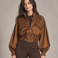 Close-up of Carlotta Moro jacket showing the front zip, chest flap details and gathered cropped hem.