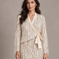 Close-up of the Cassandra Panna fringe wrap jacket with a side tie, worn with the matching Consuelo sequin skirt.