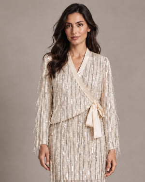 Close-up of the Cassandra Panna fringe wrap jacket with a side tie, worn with the matching Consuelo sequin skirt.