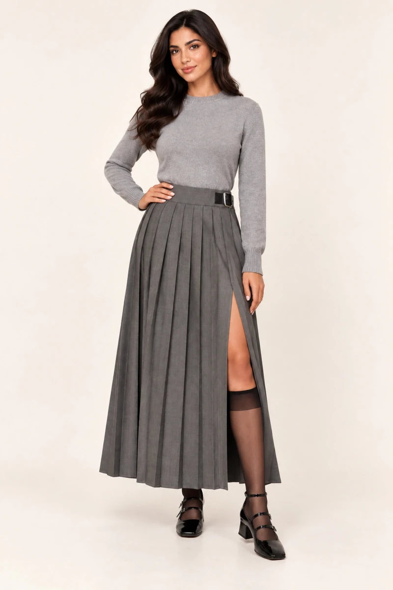 Model wearing ELLY Eleganza Skirt in Grigio with a grey sweater and black strappy heels, full-length view with hand on hip.