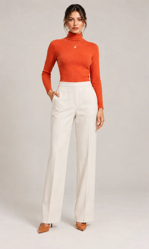 Full-length front view of the ivory Elisa Panna tailored trousers, styled with an orange long-sleeve top.