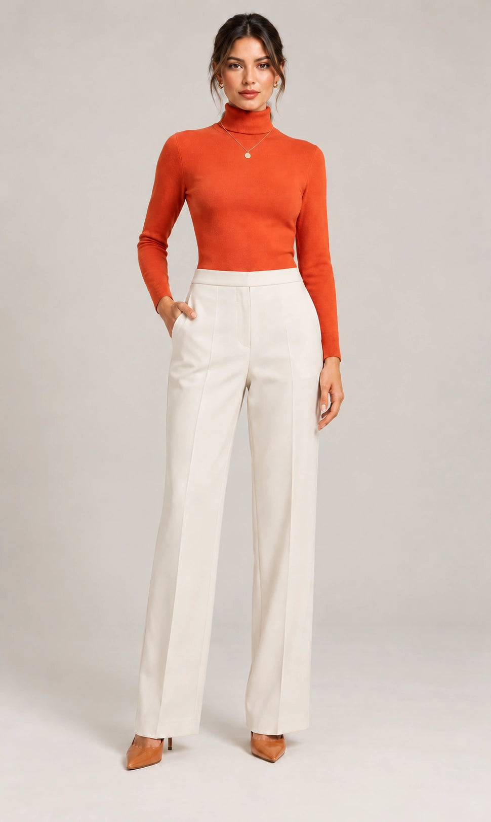 Full-length front view of the ivory Elisa Panna tailored trousers, styled with an orange long-sleeve top.
