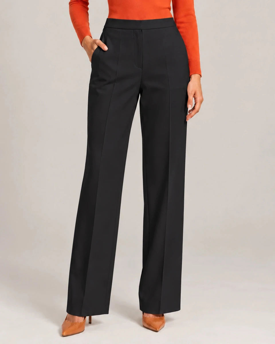 Front detail of Elisa Nero tailored trousers showing the clean waistband, side pocket and pressed leg creases.