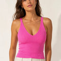 Model wearing the ELLY fuchsia ribbed knit crop top with a fitted V-neck silhouette.
