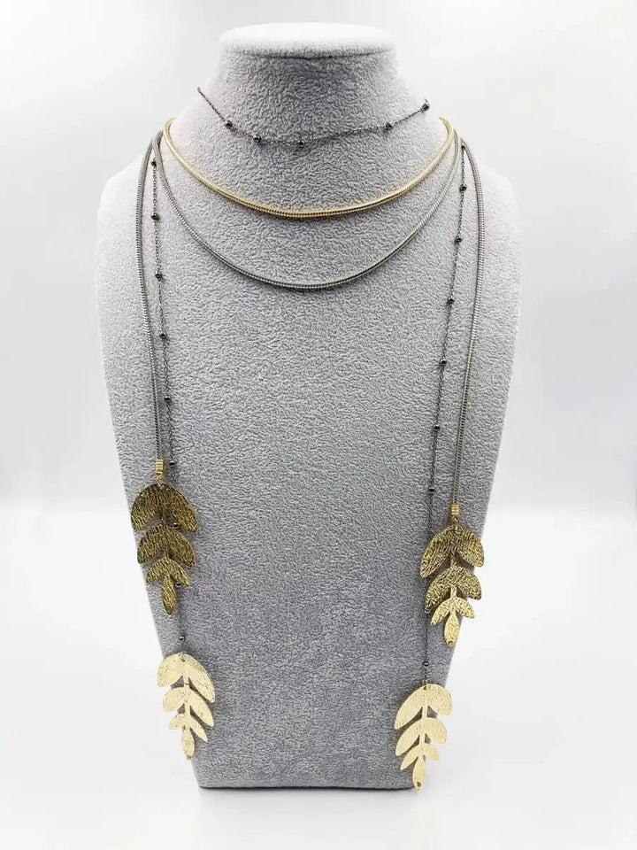 Handmade necklace, featuring a black rhodium coated metal chain and a stunning ornament adorned with yellow gold finishes - ELLY