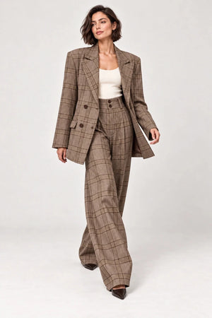 Rosalinda brown check blazer and matching Hope wide-leg trousers shown walking, styled with an ivory sleeveless top.