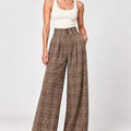 Full-length front view of Hope brown check wide-leg trousers styled with an ivory sleeveless top.