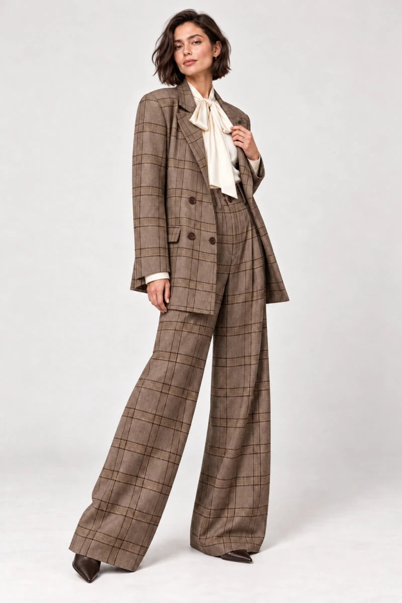 Rosalinda brown check blazer and matching Hope wide-leg trousers shown in a three-quarter view, styled with an ivory bow-neck blouse.
