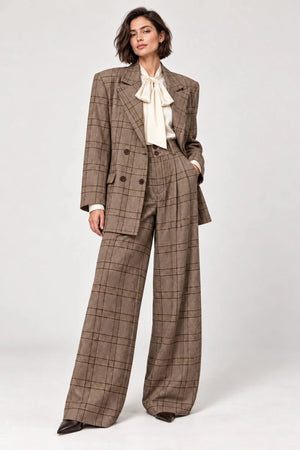 Rosalinda brown check blazer and matching Hope wide-leg trousers shown standing, styled with an ivory bow-neck blouse.