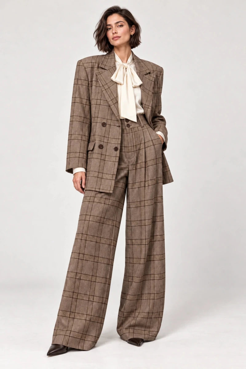 Rosalinda brown check blazer and matching Hope wide-leg trousers shown standing, styled with an ivory bow-neck blouse.