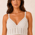 Model wearing the ELLY ivory handmade crochet crop top with textured openwork detailing.