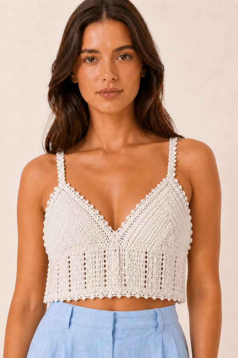 Model wearing the ELLY ivory handmade crochet crop top with textured openwork detailing.