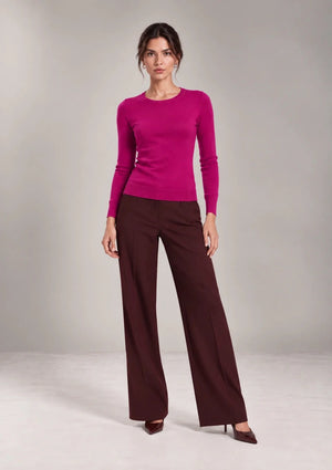 Full-length view of a model wearing the Livia Fuchsia crew-neck knit top.