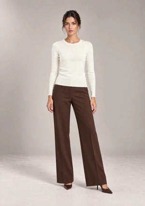 Full-length view of a model wearing the Livia Panna crew-neck knit top.
