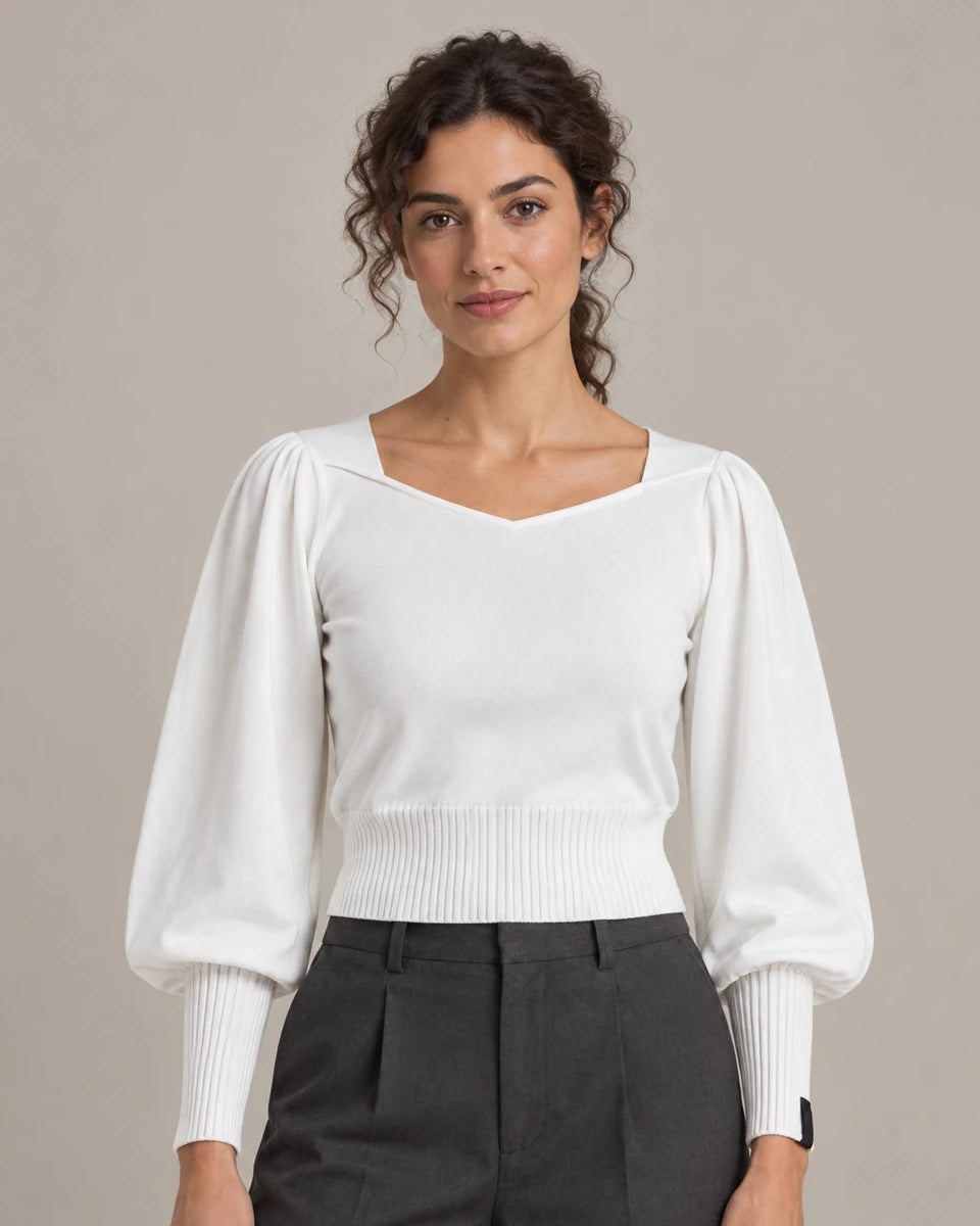 Close-up of Maglioncino Panna cream knit top showing the V-neckline, balloon sleeves and ribbed hem