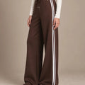 Mara Moro wide-leg track pants showing the drawstring waistband, small star detail and paired white side stripes.