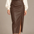 Close-up front view of the brown belted leather-look midi skirt, showing the buckle, star charm and front slit.