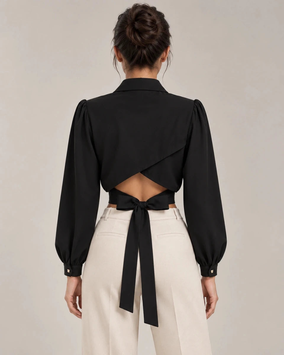 Back view of Mirella cropped shirt in Nero, showing crossover panels, a lower-back cut-out and waist ties.